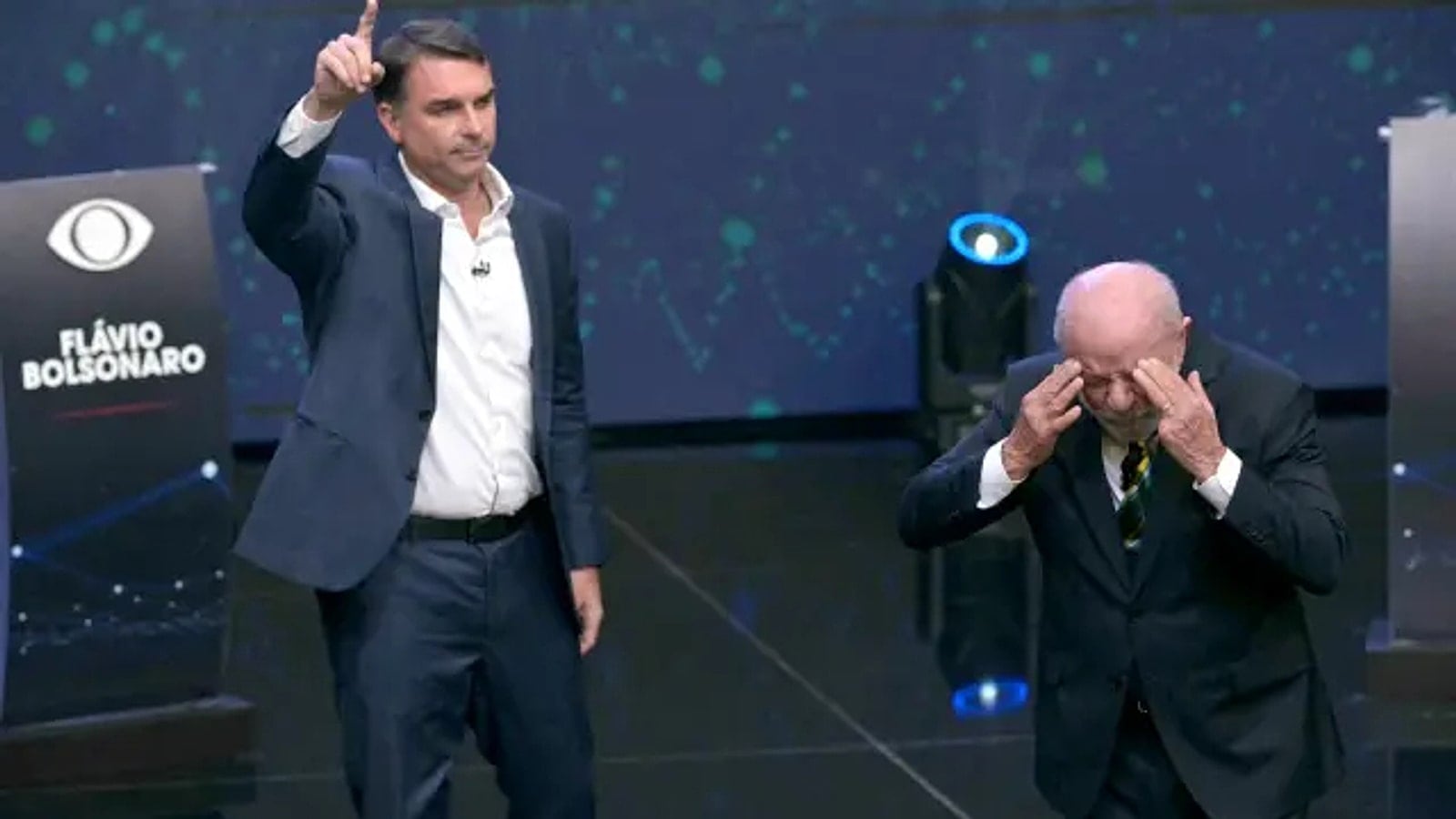 Flávio Bolsonaro e Lula em debate televisivo; a Globo definiu regras de movimentação para os blocos do confronto.